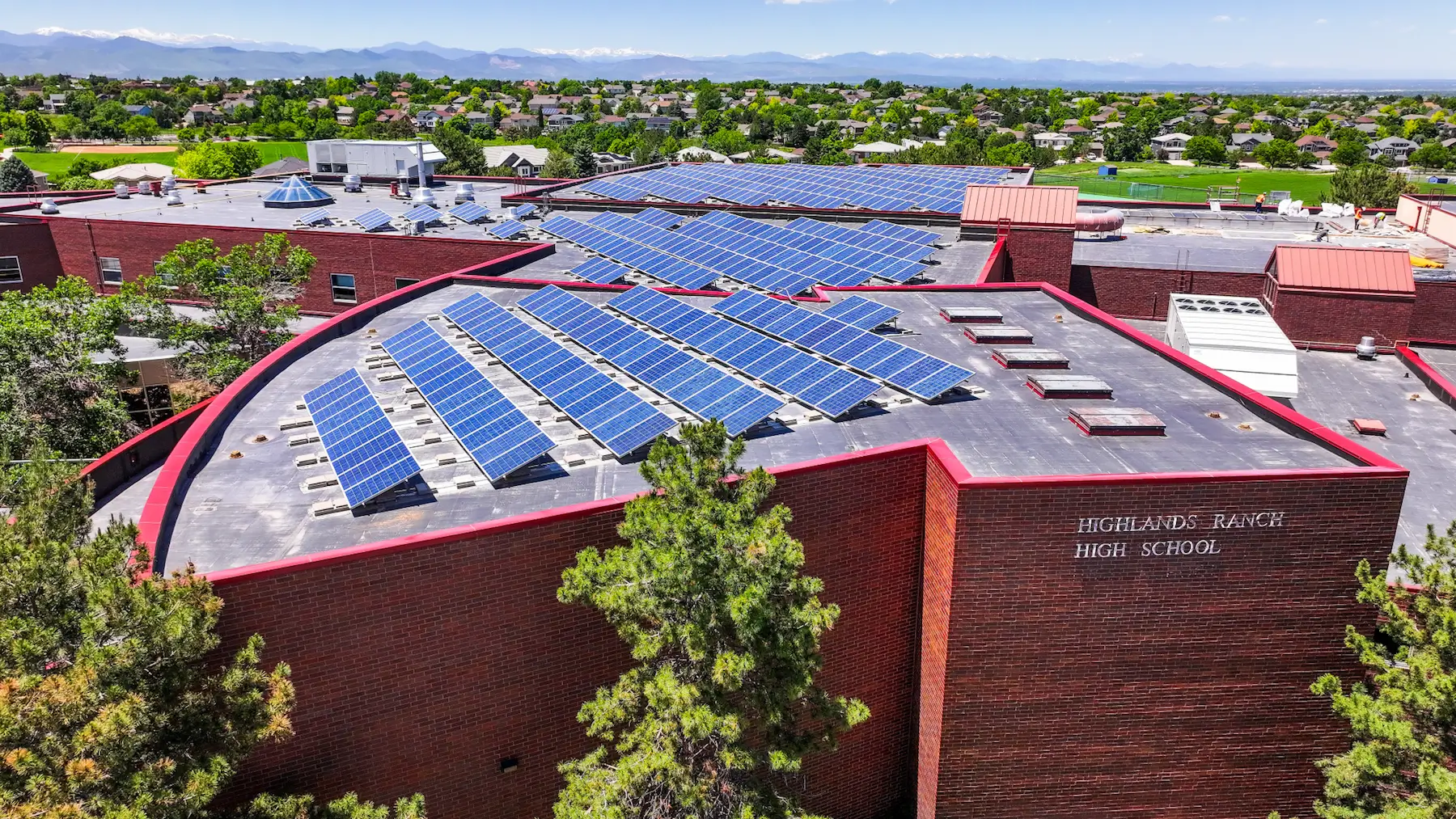 Legacy rooftop solar panel system removal and reinstallation at Highlands Ranch High School in Colorado by Vanguard Solar Services.
