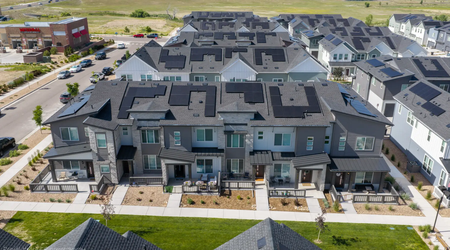 Wide aerial view of the 1671 Altura property with rooftop solar installations in Aurora