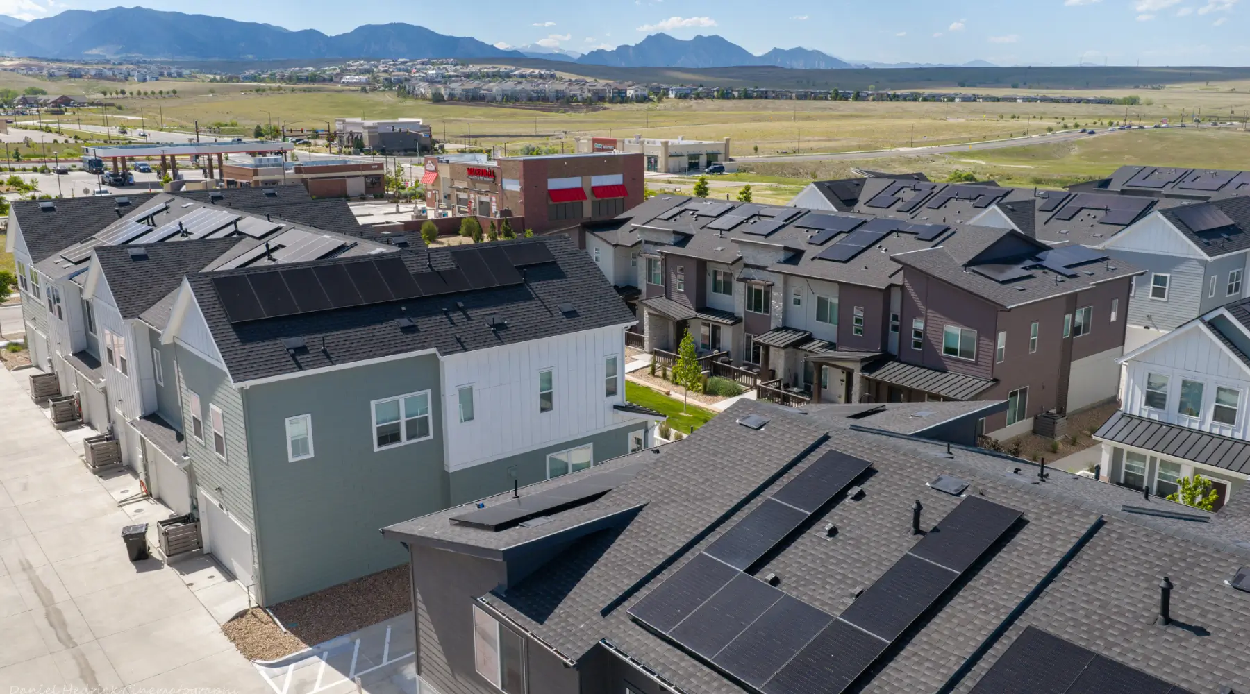 Rooftop solar panels at 1671 Altura in Aurora with Colorado mountains in the distance