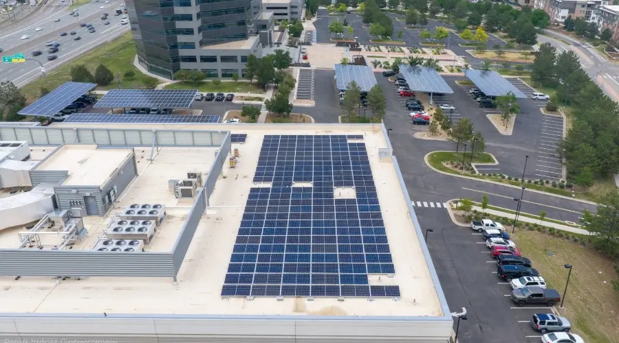 Rooftop solar panels with solar carports in the background at 169 Inverness