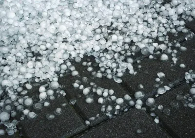 Large hailstones showing potential storm damage risk to residential solar panels