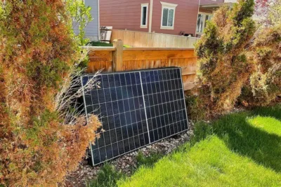 Detached residential solar panel stored safely beside a home during roof work