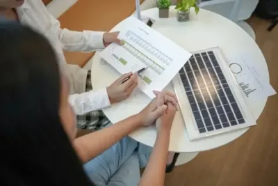 Homeowners reviewing solar panel costs and project details during a consultation